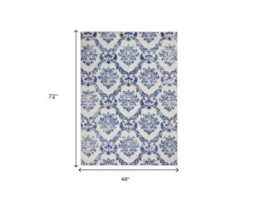 4' X 6' Ivory And Blue Damask Distressed Area Rug